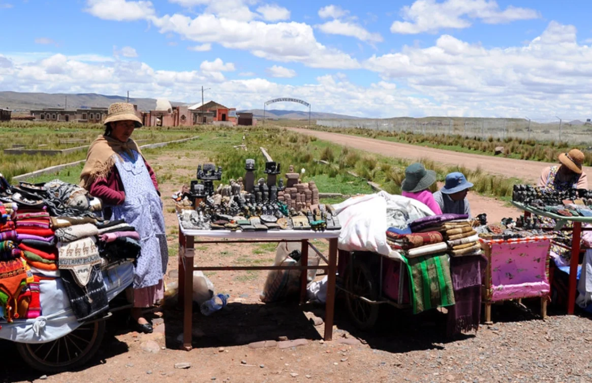 Mulheres vendem artesanato em barracas ao ar livre em Tiwanaku, Bolívia.