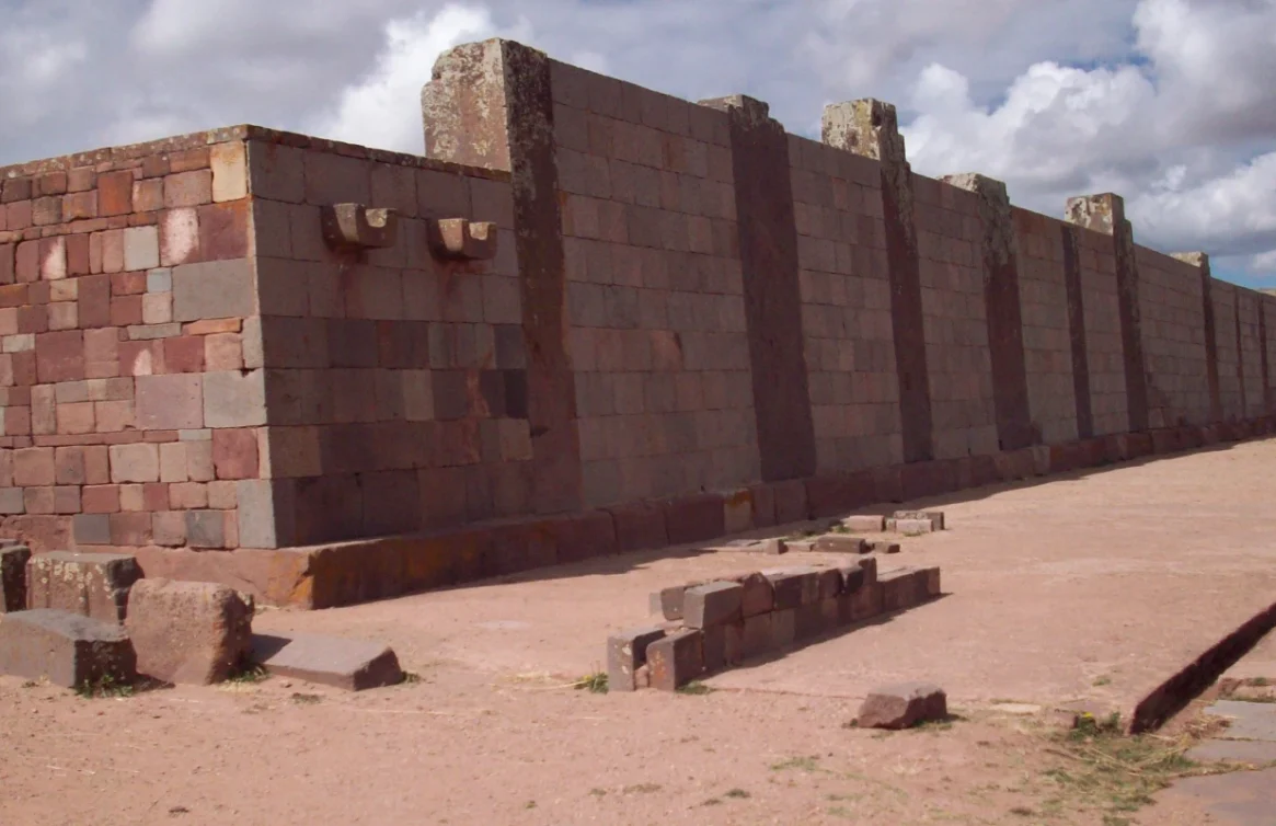 Templo Kalasasaya em Tiwanaku, com paredes de pedra e céu parcialmente nublado.